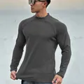 Detailed view of a charcoal gray slim-fit long-sleeve thermal athletic shirt for men. - M / Tops / Carbon Gray
