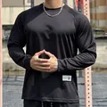 Detail of a men's loose black mesh long sleeve shirt for gym and outdoor sports - M / Tops / Black