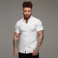 Detailed view of an athletic men's muscle fit white short sleeve button down stretch shirt - M / Tops / White