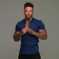 Close-up detail of navy blue muscle fit stretch shirt for men featuring a lapel collar design - Navy Blue
