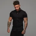 Close-up of a men's muscle fit black short sleeve stretch shirt with collar. - M / Tops / Black