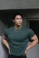 Athletic male model wearing a dark green slim-fit crew neck heavyweight fitness t-shirt - Dark Green