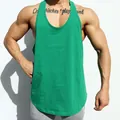 Close-up of a men's green fitness stringer tank top showing muscle-fit design - M / Tops / Green