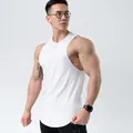 Close-up of white slim-fit cotton sports tank top on a muscular male model for gym training - M / Tops / White