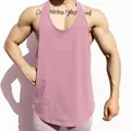 Close-up detail of a pink breathable cotton gym stringer tank top on a muscular model - M / Tops / Plain Solid Pink