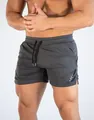 Detail showing the breathable mesh fabric and side slit of the grey running shorts. - M / Bottoms / Gray
