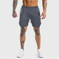 Detail view of dark grey slim-fit men's athletic training shorts with drawstring waist - M / Bottoms / Dark Gray