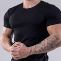 Detail of men's slim fit athletic black t-shirt showing muscle definition - M / Top (25-DT-01) / Black