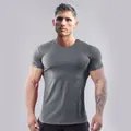 Slim fit grey athletic t-shirt showing muscle definition and stretch fabric detail - Dark Gray