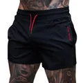 Black elastic gym shorts for men, ideal for breathable running and deep squat training - M / Bottoms / Black With Red Letters