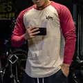 Close-up of a men's raglan long-sleeve fitness T-shirt in two-tone red and off-white - Tops / M / White and Burgundy Sleeves