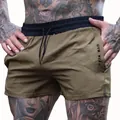 Men's breathable brown athletic gym shorts featuring black elastic waist and drawstring - M / Bottoms / Khaki Black Waist