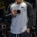 Detailed view of a slim fit men's raglan long sleeve gym T-shirt in grey and black - Tops / M / Gray and Black Sleeves