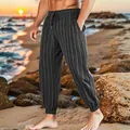 Detailed view of breathable men's striped linen casual pants worn on a beach at sunset - S / Bottoms / Black