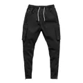 Detail view of men's black sports cargo pants with zippered pockets and drawstrings - M / Bottoms / Black