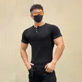 Detail shot of men's muscle fit black ribbed short sleeve Henley t-shirt - M / Tops / Black