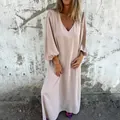 Detail showing the elegant V-neckline and loose lantern sleeves of this beige maxi dress. - S / Top And Bottom / Apricot