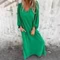 Detailed visual of a vibrant green V-neck maxi dress featuring elegant lantern sleeves - Green