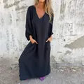 Casual loose V-neck maxi dress with lantern sleeves and side pockets on model - S / Top And Bottom / Black