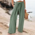Comfortable high-waisted green wide-leg casual pants with drawstring waist on a beach - Light Green