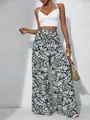 Close-up of women's summer wide-leg casual pants featuring a vibrant tropical leaf print - S / Bottoms / Green