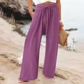 Detail showing purple wide-leg pants with elastic drawstring waist and side pockets. - Fuschia