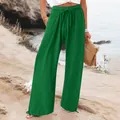 A close-up detail of casual green wide-leg trousers featuring an elastic drawstring waist - Green