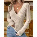 Detailed view of beige ribbed knit sweater showing cross V-neck and slim fit texture - S / Tops / Apricot