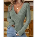 Detail shot showing the deep V-neckline and elegant ribbed texture of this slim-fit green top. - S / Tops / Green