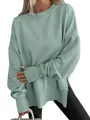 Detailed view of mint green oversized sweatshirt with side slits and batwing sleeves. - S / Tops / Emerald Green