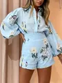 Detailed view of light blue floral print shirt and high-waisted shorts two-piece set - S / Top And Bottom / Light Blue
