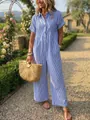 Vista dettagliata della tuta intera a righe bianche e blu in un ambiente esterno. - Taglia S / Top E Pantaloni / Blu