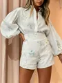 Detail shot of a floral print button-down shirt and high-waisted shorts two-piece set - S / Top And Bottom / White Small Sunflower Style