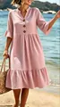 Close-up detail of pink polka dot V-neck dress with ruffle sleeves and tiered hem. - Pink Polka Dot