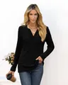 Detailed macro view of women's black ribbed knit long-sleeved top with elegant V-neckline - S / Tops / Black