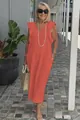 Detail view of a coral cotton linen maxi dress with ruffle sleeves and V-neck on a model - S / Bottoms / Orange Red