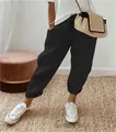 Close-up detail of women's black cotton linen elastic waist cropped casual pants with pockets. - Black