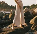 Detailed shot of high-waisted wide-leg yoga pants with irregular hems in nature - S / Bottoms / Apricot