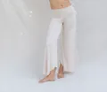 Close-up detail of off-white high-waisted yoga pants featuring a stylish irregular hemline. - S / Bottoms / White