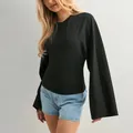 Professional detail view of a black long sleeve top with flared sleeves and slim waist - XS / Top (Small Cuff) / Black