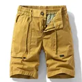 Men's loose cargo shorts with large pockets in mustard yellow, elastic drawstring waist. - 28 / Bottoms / Earthy Yellow
