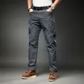 Professional studio shot of men's dark grey multi-pocket elastic cargo pants variant - Gray