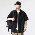 Men's short-sleeved black cargo shirt with dual chest pockets and a relaxed retro fit - M / Tops / Black