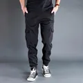 Close-up detail of mens black cargo jogger pants with side flap pockets and elastic cuffs - M 100-130 Jin / Bottoms / Black (Summer Thin)