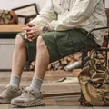 Stylish men's army green cotton cargo shorts captured in a professional rustic setting - 29 / Bottoms / Army Green