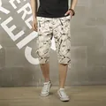 Men's off-white cargo seven-point shorts with brown abstract print and multi-pockets - 28 / Bottoms / Off White