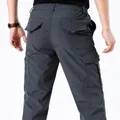 Back view of men's gray quick-dry outdoor cargo pants featuring multiple utility pockets - Mid-weight Gray