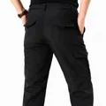 Back view of black outdoor waterproof quick-dry cargo pants for men with multi-pocket design - Mid-weight Black