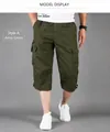 Detail shot of men's loose fit army green cargo shorts made of pure cotton fabric - M / Bottoms / Army Green