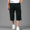 Close-up detail view of men's casual black cotton cargo 3/4 length shorts with pockets - M / Bottoms / Black